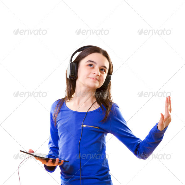 Smiling Girl Listening to Music on Digital Tablet (Misc) Photo Download