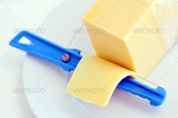 Yellow cheese slice and Cheese slicer