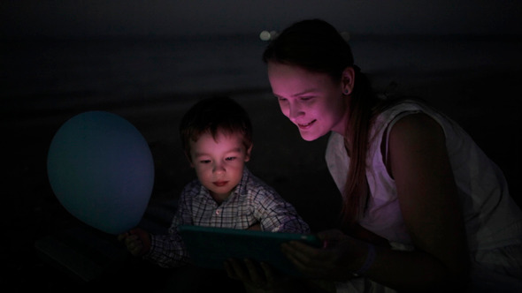 Kid With Mom on Beach At Night Kid With Mom on Beach At Night