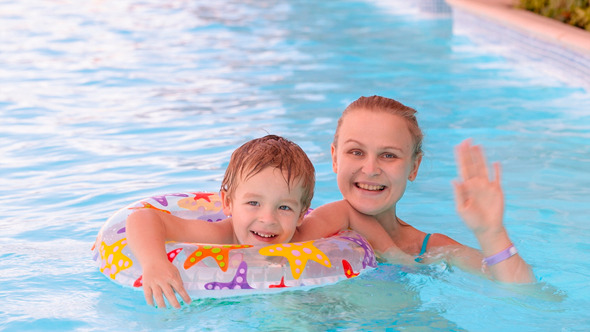 Mom And Son Swimming in Pool Mom And Son Swimming in Pool