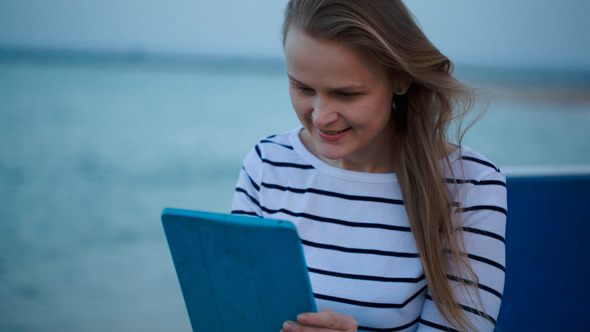Young Woman Using Tablet Pc By Sea Young Woman Using Tablet Pc By Sea