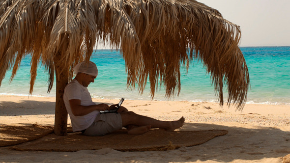 Man Using Laptop on Beach Man Using Laptop on Beach