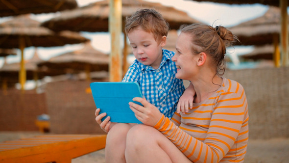 Little Boy With Is Mother At A Beach Resort Little Boy With Is Mother At A Beach Resort