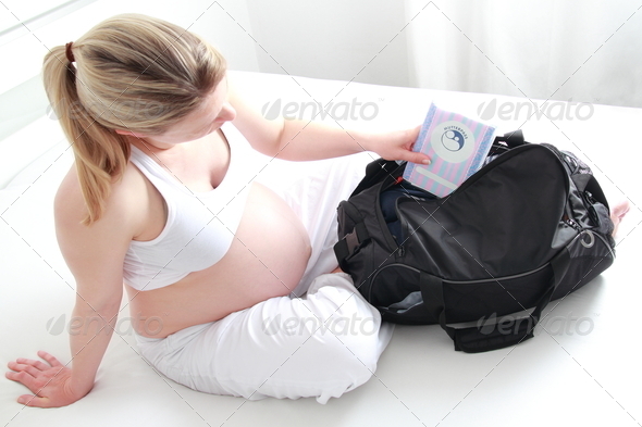 Pregnant woman packing hospital bag