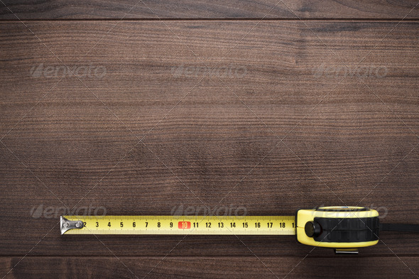 Tape Measure On The Wooden Background