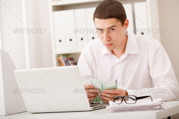 man with laptop and money