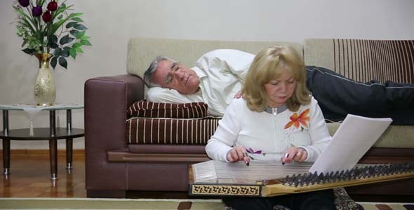 Woman Playing Qanun While Husband Listening Woman Playing Qanun While Husband Listening