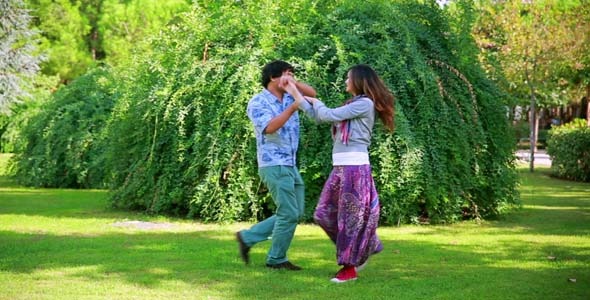 Young Couple Relaxing On Lawn In A City Park Young Couple Relaxing On Lawn In A City Park