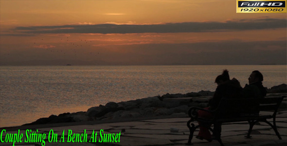 Couple Sitting On a Bench At Sunset Couple Sitting On a Bench At Sunset