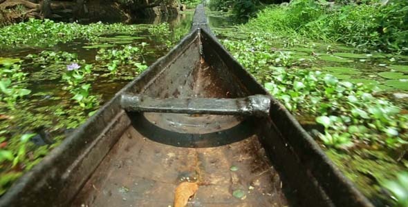 Boat Moving Along Canal At Sunset In Kerala Boat Moving Along Canal At Sunset In Kerala