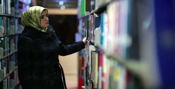 Female Student Wandering Between Shelves Female Student Wandering Between Shelves