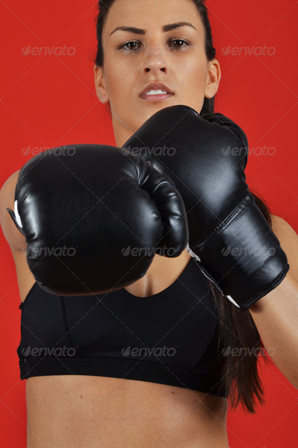 beautiful fitness woman with the black boxing gloves