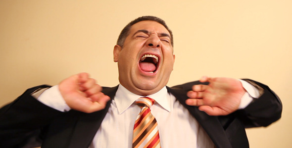 Tired Businessman Yawning And Stretching Tired Businessman Yawning And Stretching