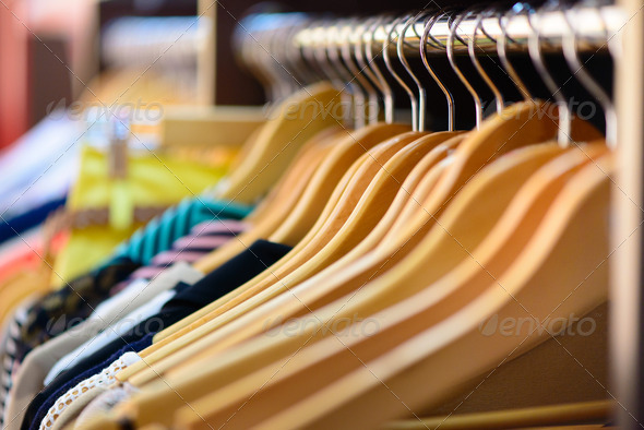 Variety of clothes hanging on rack
