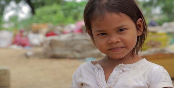 Cambodian Girl In Slums Garbage in Background Cambodian Girl In Slums Garbage in Background