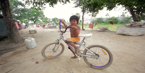 Cambodian Boy In Slum Shacks in Background Cambodian Boy In Slum Shacks in Background