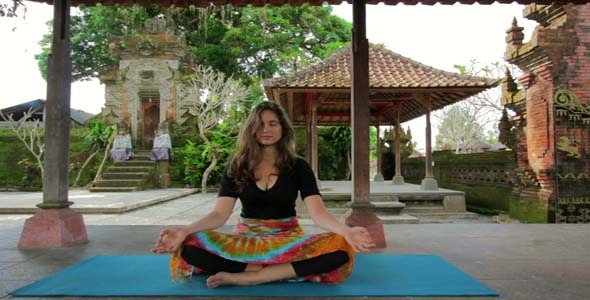 Caucasian Woman Meditating Yoga In Balinese Temple Caucasian Woman Meditating Yoga In Balinese Temple