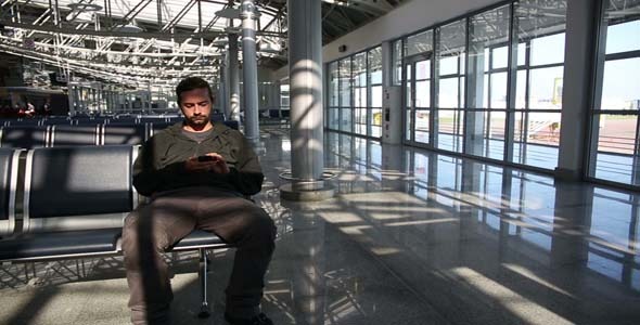 Man Using Mobile Phone At Airport Man Using Mobile Phone At Airport