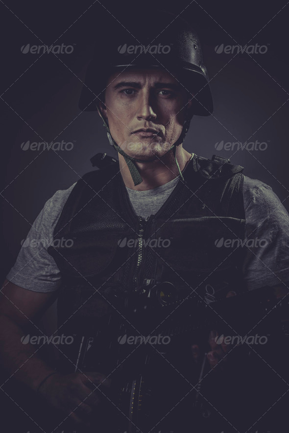 Uniform player wearing protective helmet aiming pistol ,black ar