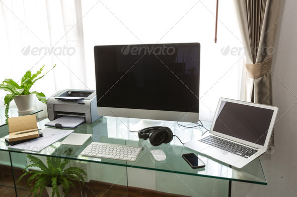 Modern home office with computer and labtop