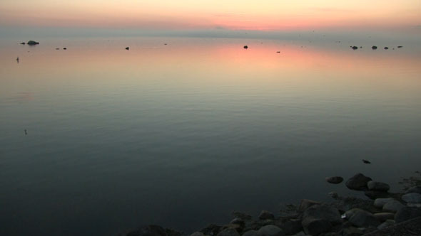 Calm Sea At The Beach With A Sunset Glow Calm Sea At The Beach With A Sunset Glow