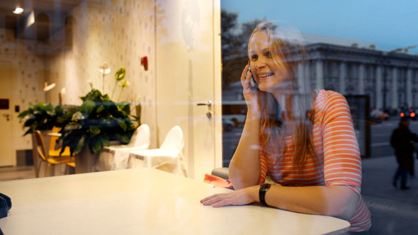 Evening Phone Talk Of A Young Woman In Cafe Evening Phone Talk Of A Young Woman In Cafe