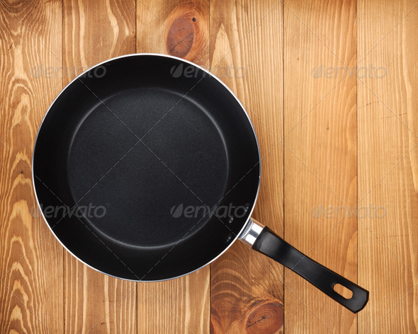 Frying pan on wooden table (Misc) Photo Download