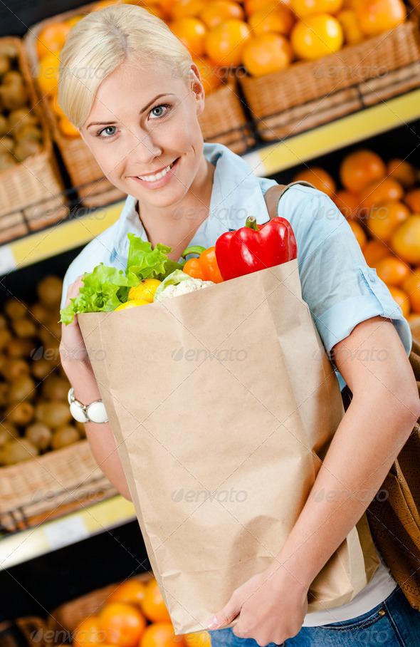 Girl hands package with fresh vegetables
