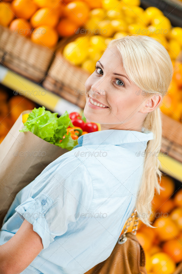 Girl holds packet with fresh vegetables