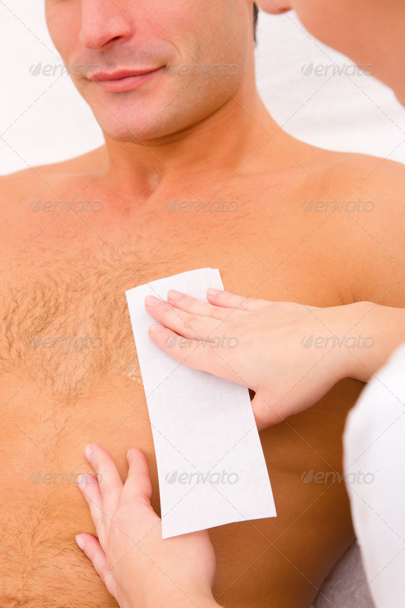 Man waxing his chest hair