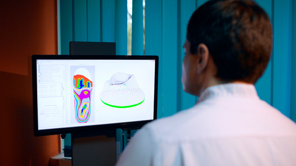 Doctor Working With Shoe Modeling Using Foot Scan Doctor Working With Shoe Modeling Using Foot Scan