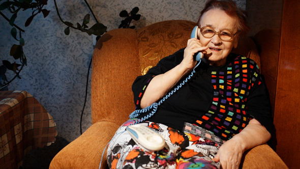 Old Woman Receiving A Phone Call In The Evening Old Woman Receiving A Phone Call In The Evening