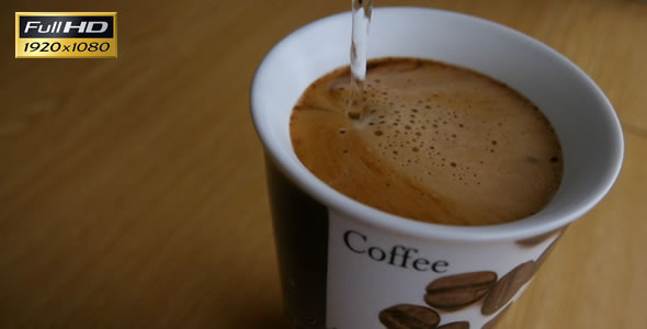 Pouring Water Into A Cup of Coffee Pouring Water Into A Cup of Coffee