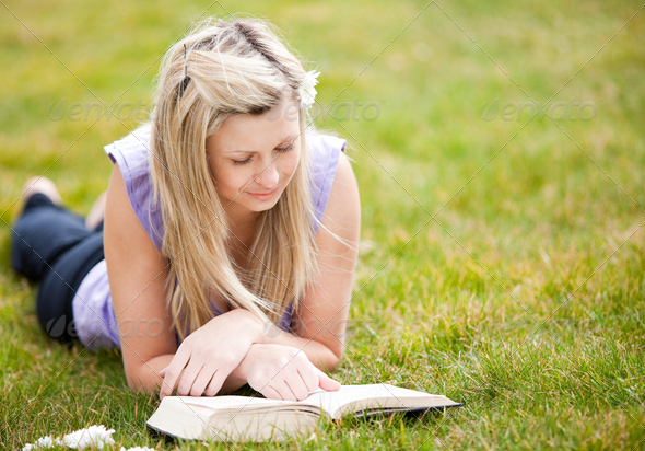 Beautiful woman reading a book in a park (Misc) Photo Download