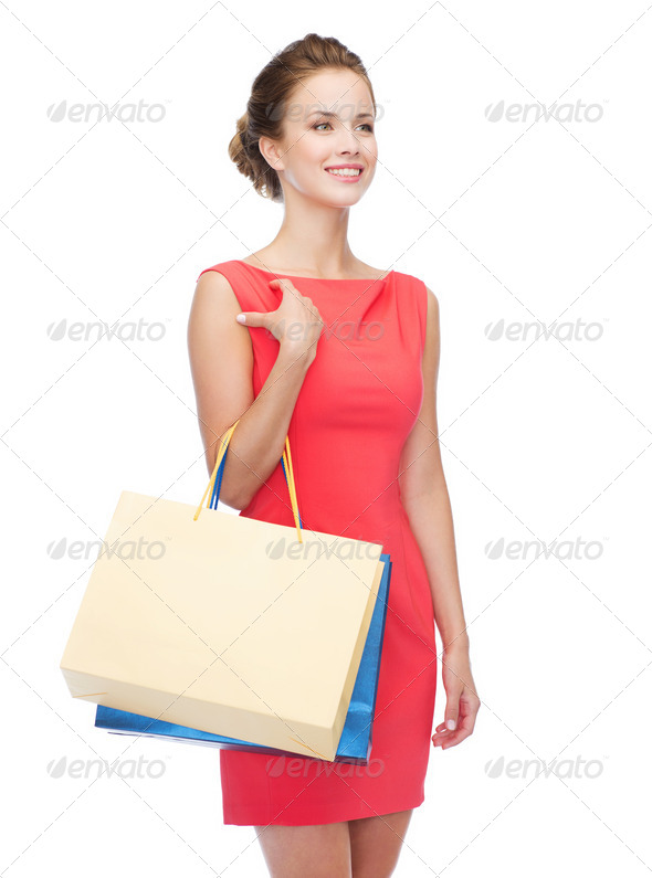 smiling elegant woman in dress with shopping bags (Misc) Photo Download