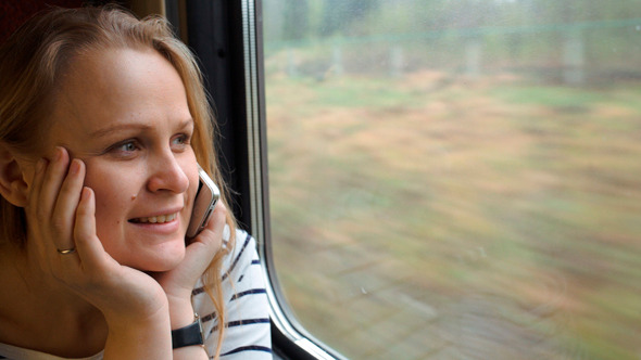 Young Woman Talking On The Phone While Traveling Young Woman Talking On The Phone While Traveling