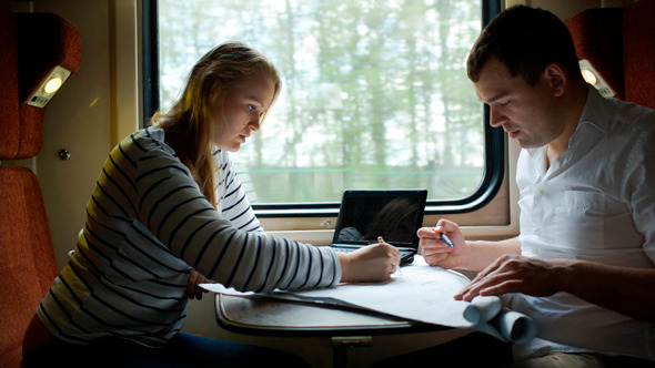 Man And Woman Discussing Drawing During Business Man And Woman Discussing Drawing During Business