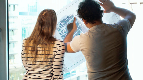 Two Architects Discussing A Project Looking Two Architects Discussing A Project Looking