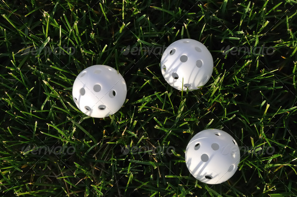 Three White Plastic Wiffle Golf Balls