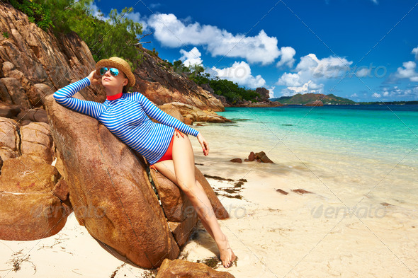 Woman at beautiful beach wearing rash guard