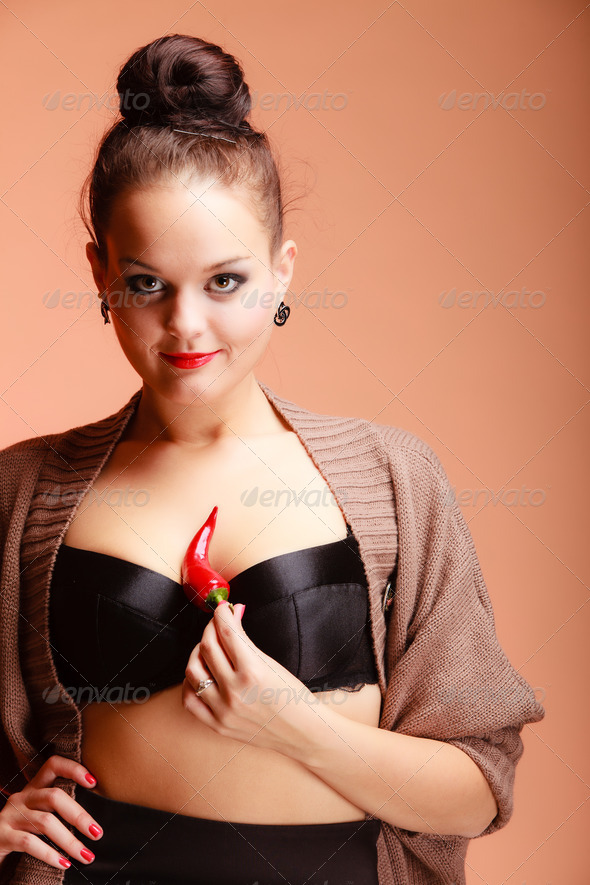 Beautiful woman fashion girl with red lips holds chilli pepper (Misc) Photo Download