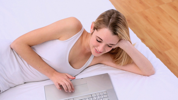 Happy Gorgeous Blonde Lying On Bed Using Laptop Happy Gorgeous Blonde Lying On Bed Using Laptop