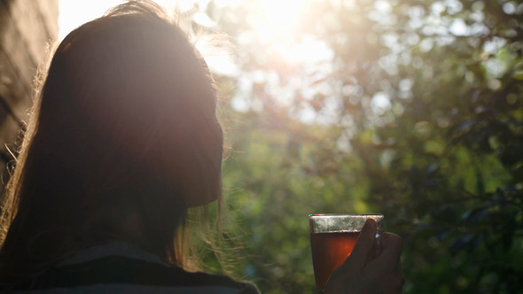 Woman Having Tea Outdoor During Sunset Woman Having Tea Outdoor During Sunset