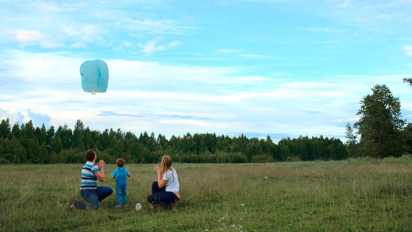 Parents And Their Son Flying A Fire Lantern Parents And Their Son Flying A Fire Lantern