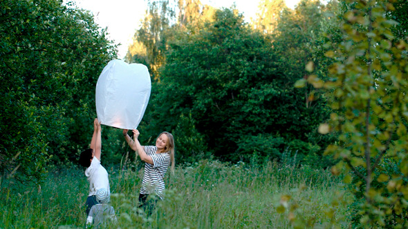 Family Flying A Fire Lantern In The Woods Family Flying A Fire Lantern In The Woods