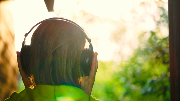 Girl Listening To Music In Headphones Outdoor