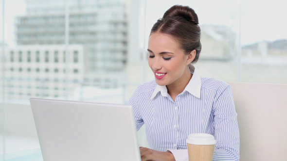 Young Businesswoman Working On Her Laptop Drinking Young Businesswoman Working On Her Laptop Drinking