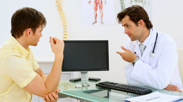 Young Doctor Speaking With His Patient Young Doctor Speaking With His Patient