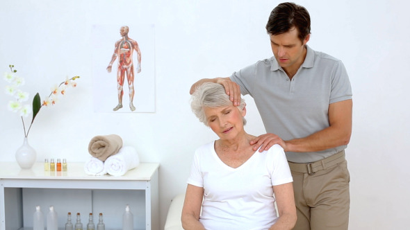 Physiotherapist Checking Senior Patients Neck Physiotherapist Checking Senior Patients Neck