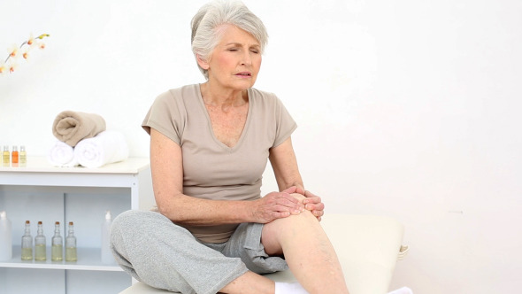 Injured Patient Rubbing Her Painful Knee Injured Patient Rubbing Her Painful Knee